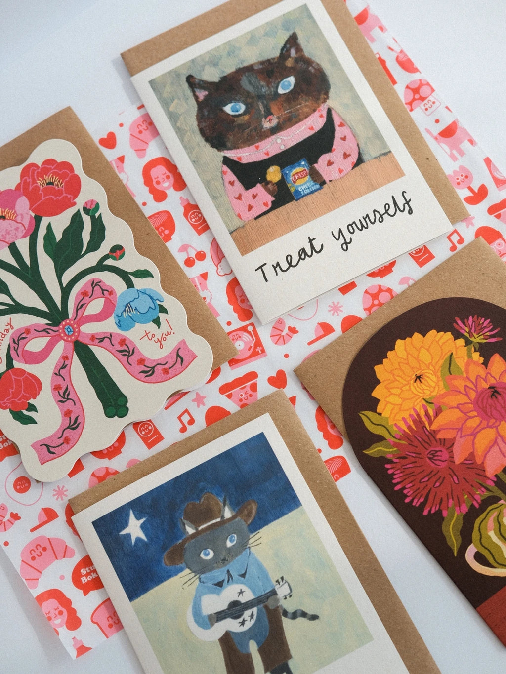 Collection of greeting cards with cat illustrations and floral designs on a white background.