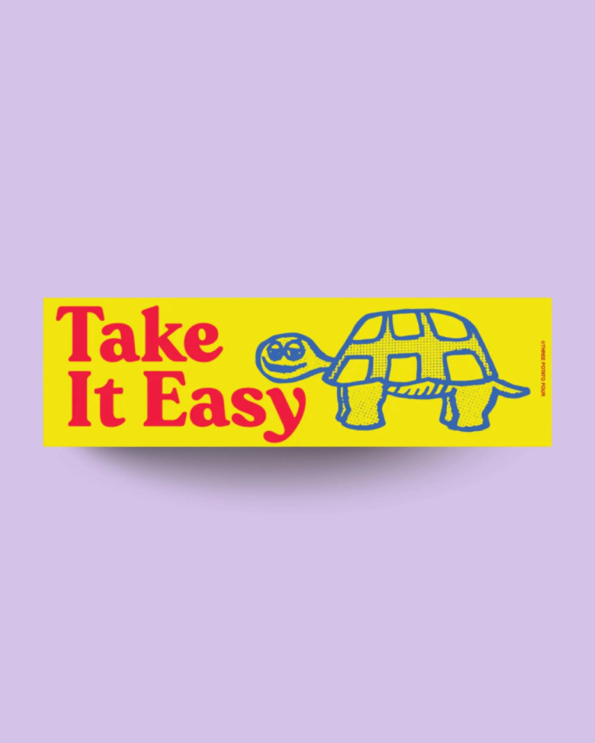 Yellow bumper sticker with a turtle graphic and 'Take It Easy' text on a purple background