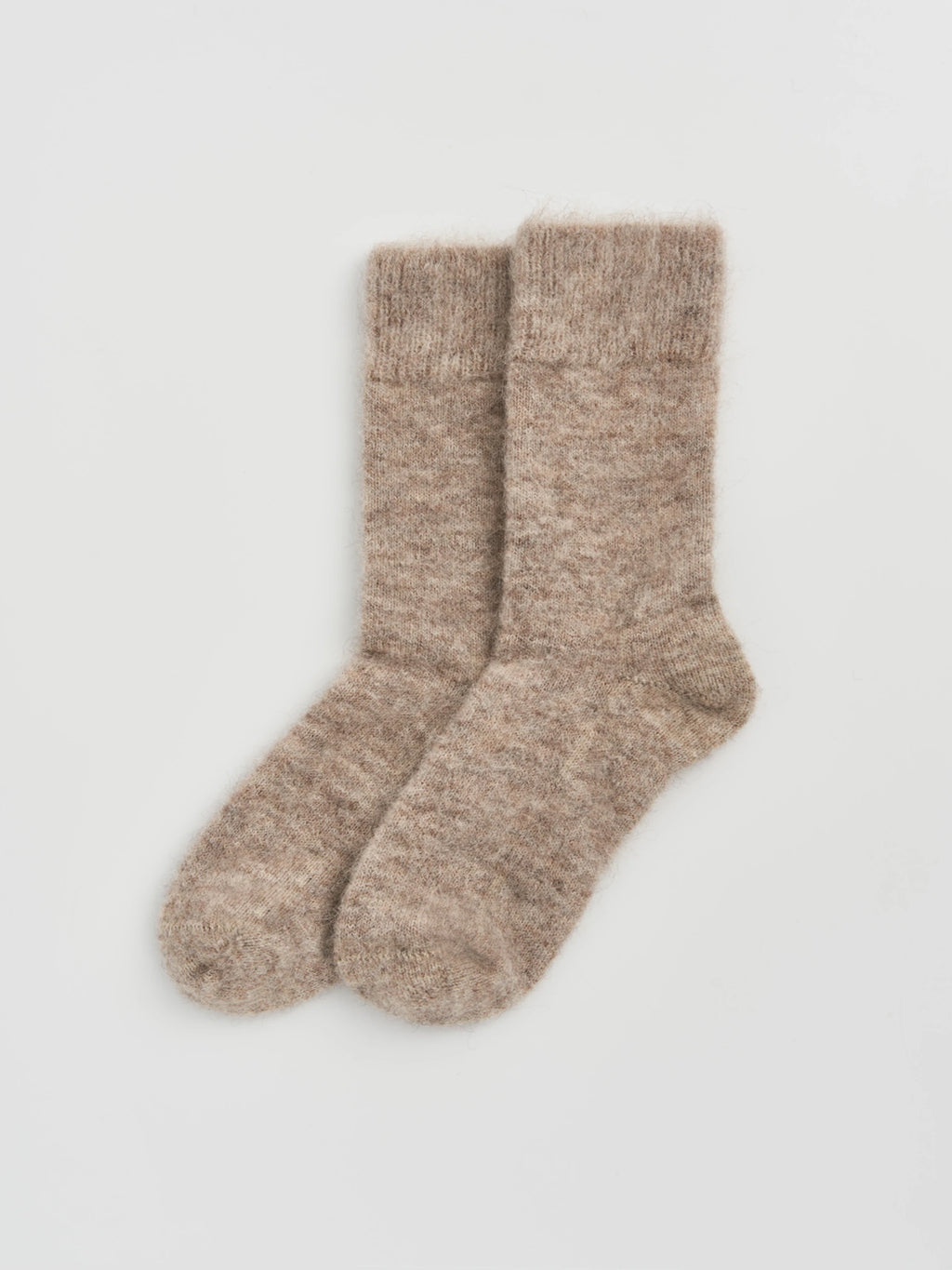 Pair of hare grey alpaca socks on a light gray background