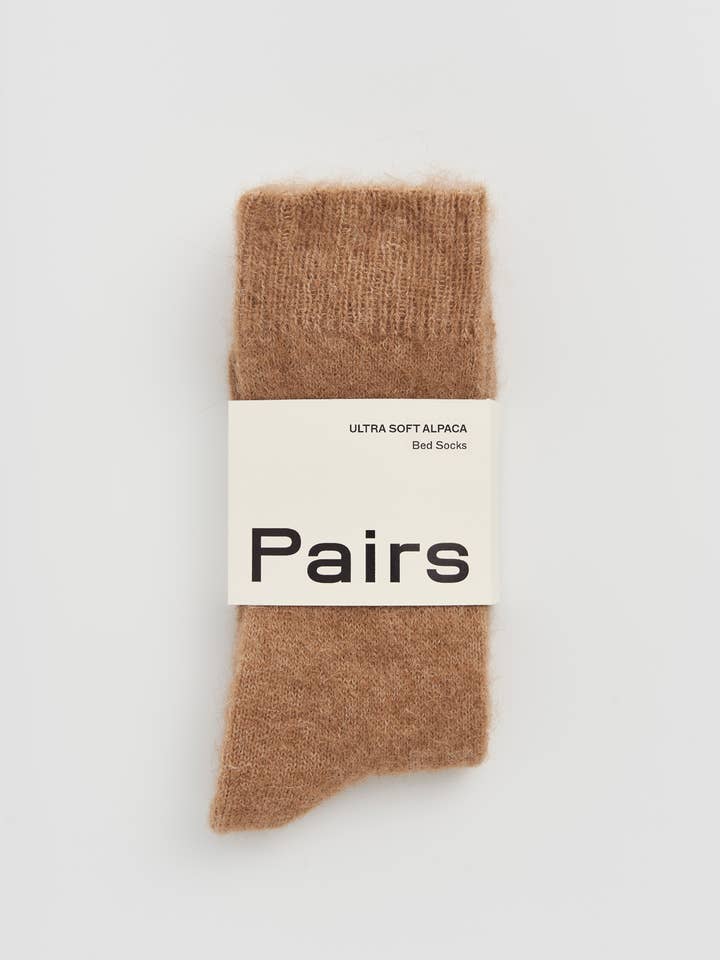 Brown sock with 'Pairs' label on a white background