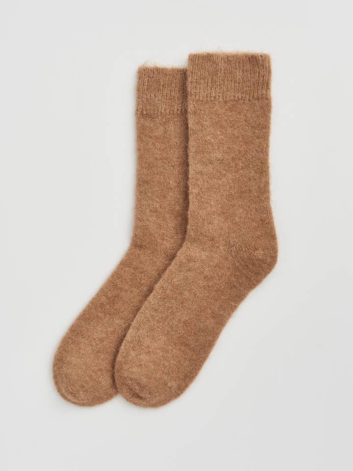 Pair of brown socks on a light gray background
