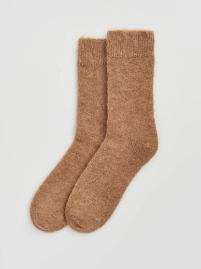 Pair of brown socks on a light gray background
