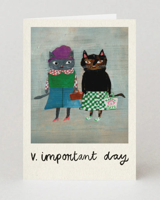 Greeting card with two cats in costumes and the text 'v. important day' on a light gray background.