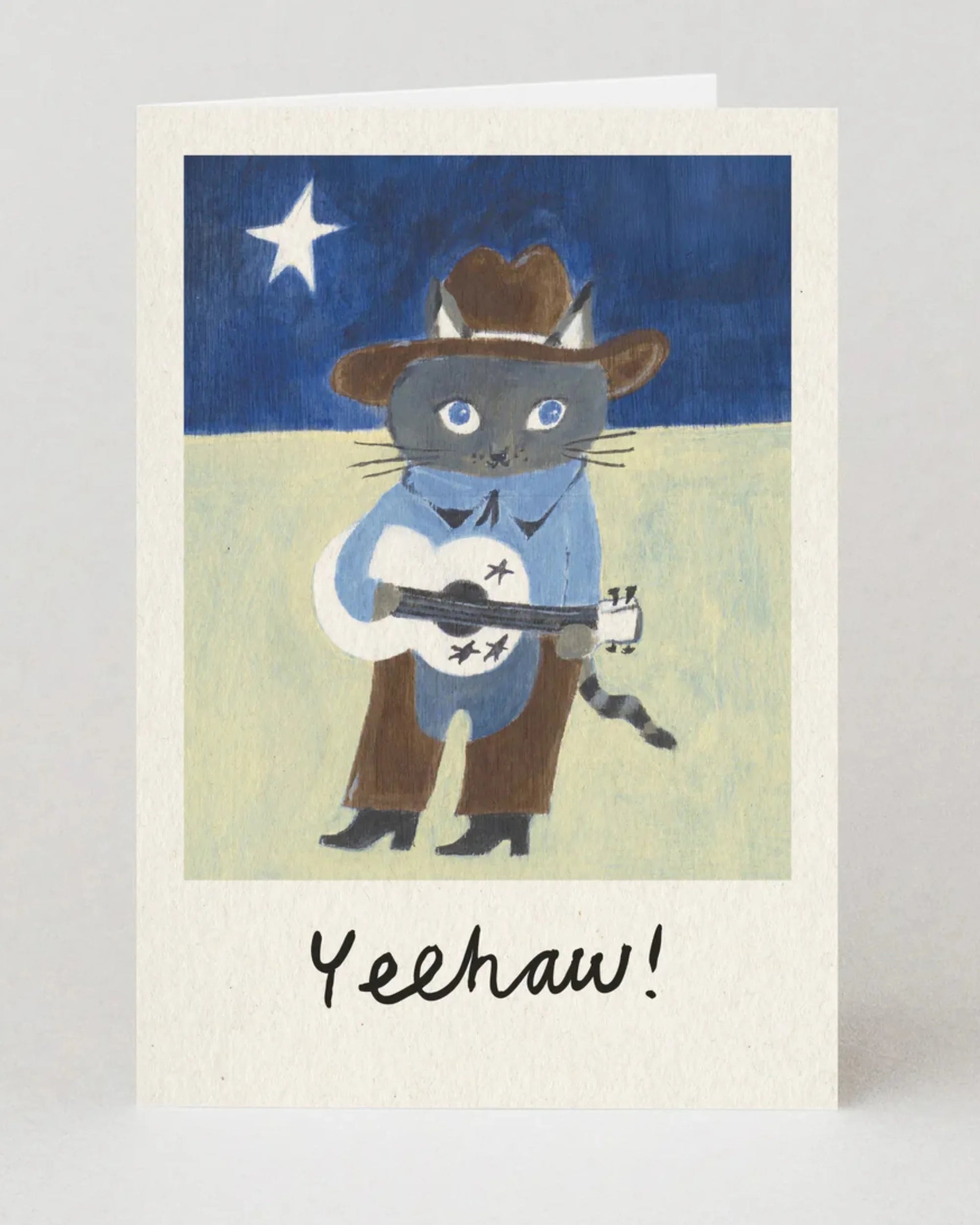 Card with a cat wearing a cowboy hat and boots, holding a guitar, with 'Yeehaw!' text on a starry night background.