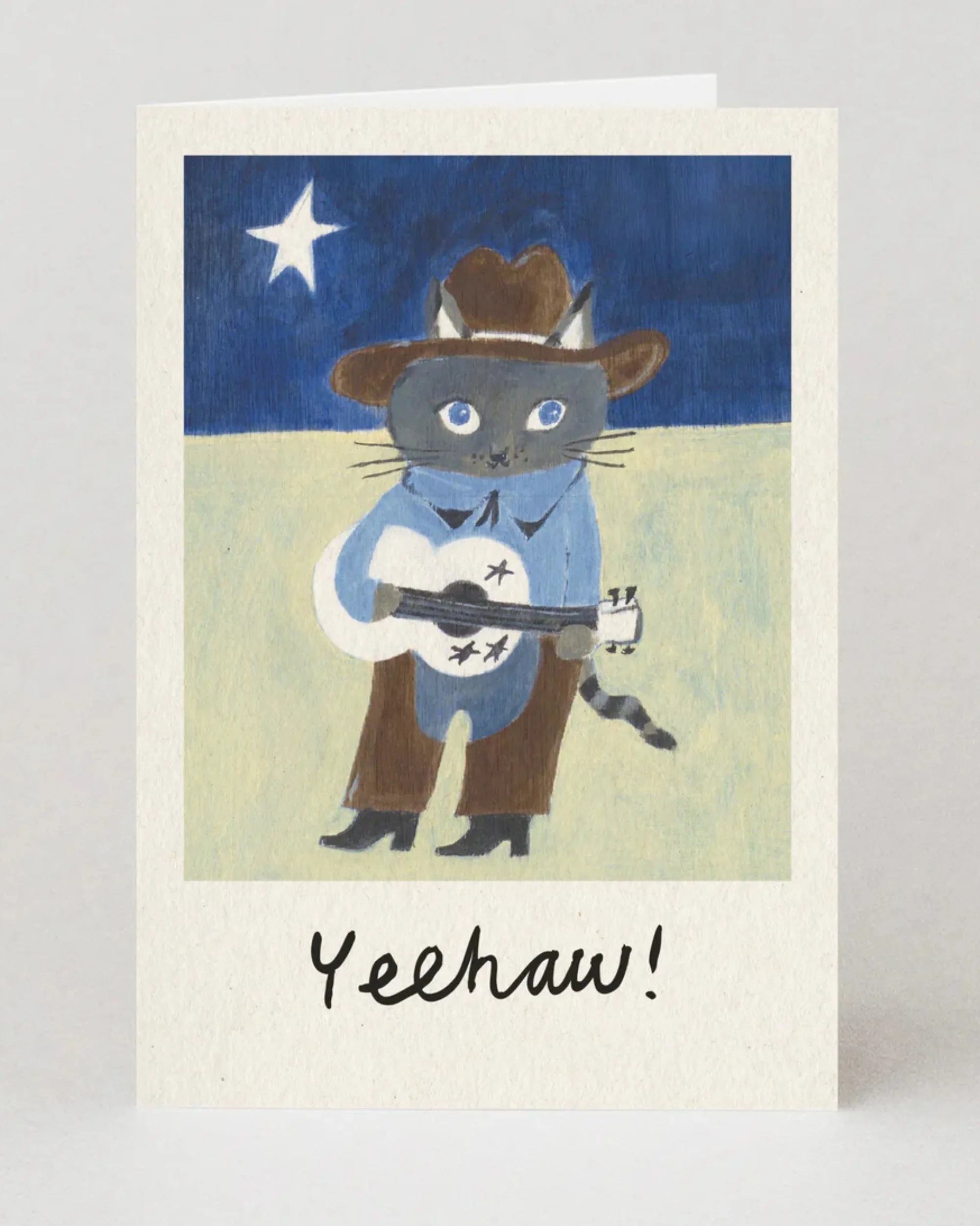 Card with a cat wearing a cowboy hat and boots, holding a guitar, with 'Yeehaw!' text on a starry night background.